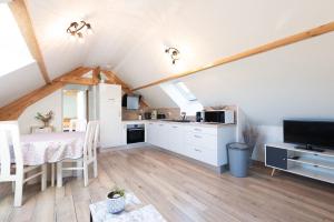 a kitchen and dining room with a table in a attic at Chalet 2 Pièces Avec Terrasse in Ouzous +11 photos