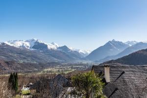 a view of snow covered mountains from a house at Chalet 2 Pièces Avec Terrasse in Ouzous