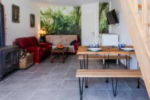 a living room with a couch and a table at Le Luna in Vindelle