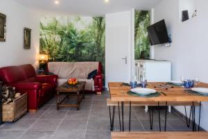 a living room with a couch and a table at Le Luna in Vindelle