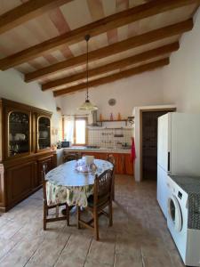 a kitchen with a table and a white refrigerator at The Paradise in Esporles