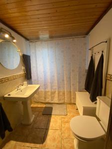 a bathroom with a sink and a toilet and a mirror at The Paradise in Esporles +9 photos