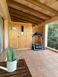 a room with a gym with a treadmill on a patio at The Paradise in Esporles
