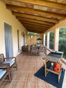 a patio with a table and chairs and a wooden ceiling at The Paradise in Esporles