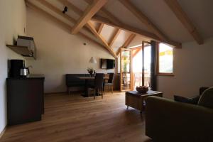 a living room with a couch and a table at Greiterhof in Lana