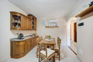 a kitchen with a wooden table and chairs and a counter at Agriturismo U'Spigu Nonna Annetta in Nasino