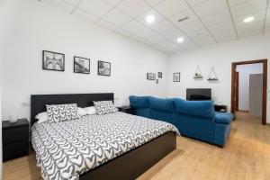 a bedroom with a bed and a blue couch at Casa Matyas in Icod de los Vinos