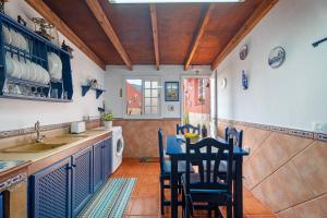 a kitchen with a table and chairs and a sink at Casa Matyas in Icod de los Vinos +21 photos