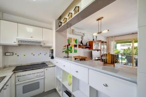 a kitchen with white cabinets and a counter top at Cambrils park in Cambrils