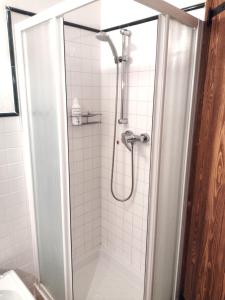 a shower in a bathroom with white tiles at Le Ortensie Lago di Garda in Monzambano +67 photos