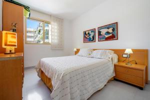 a bedroom with a bed and a window at Cambrils park in Cambrils