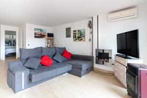 a living room with a couch and a flat screen tv at Ca La Nyca in Tossa de Mar