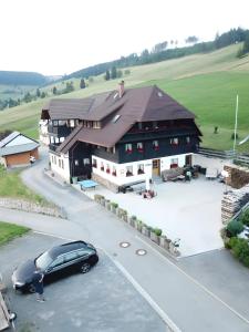 a black car parked in front of a building at Ferienwohnung Bergerhöh in Todtnauberg