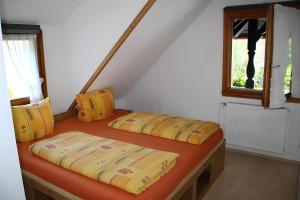 two beds in a room with a window at Ferienwohnung Bergerhöh in Todtnauberg