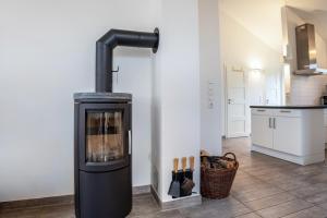 a kitchen with a wood stove in a room at Weidenuferhaus in Kosel