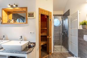 a bathroom with a sink and a shower at Weidenuferhaus in Kosel +16 photos