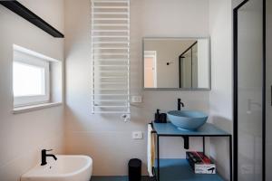 a bathroom with a sink and a mirror at Villa Capobianco in Polignano a Mare +14 photos