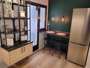 a kitchen with two counters and a refrigerator at Apartamento Ejido Centro in El Ejido