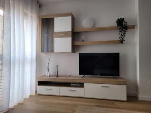 a living room with a flat screen tv on a wall at Apartamento Ejido Centro in El Ejido