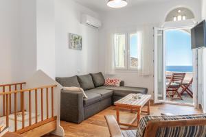 a living room with a couch and a table at Ammos Tinos in Istérnia