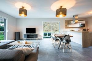 a kitchen and living room with a table and chairs at Maison vélo et ski in Saint-Jean-de-Maurienne