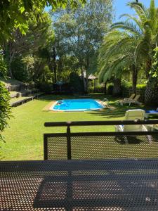 a picnic table in front of a swimming pool at Quinta Pé Franco in Medrões +20 photos