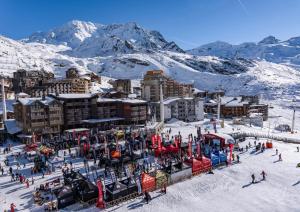 a ski resort with a train in the snow at Appartement Higginson Val Thorens in Val Thorens +6 photos