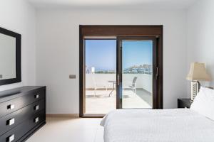 a bedroom with a bed and a view of a balcony at Chalet En La Cala De Mijas Costa in Mijas Costa +18 photos