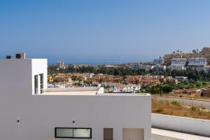 a white house with a view of a city at Chalet En La Cala De Mijas Costa in Mijas Costa
