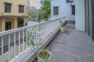 a balcony of a building with a white fence at MAY HOMESTAY Villa in Hue