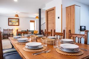 a wooden table with plates and napkins on it at Quercus in Navaluenga