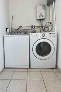 a washing machine and a washer in a room at Departamento privado in Tijuana