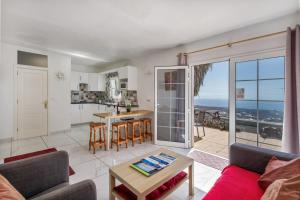 a living room with a couch and a table at Casa Eden in Tías