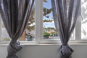 a window with blue curtains in a room at Apartamento Las Flores5 in San Bartolomé
