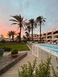 a resort with a swimming pool and palm trees at Apartamento Las Flores5 in San Bartolomé