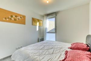 a white bedroom with a bed and a window at Chambre Villa illiade in Jacou +8 photos