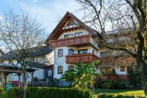 a large house with wooden balconies on it at Pension Haus Rose in Oberharmersbach