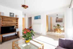 a living room with a couch and a table at Au Fil Du Réguinier - Gîte Briançon in Briançon