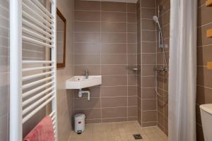 a bathroom with a shower and a sink at Au Fil Du Réguinier - Gîte Briançon in Briançon +17 photos