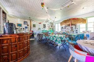 a restaurant with tables and chairs in a room at Gite de l'Ecluse in Bassanne