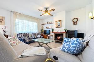 a living room with a couch and a fireplace at Casa Anglada in Calafell