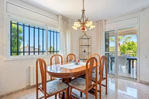 a dining room with a table and chairs at Casa Anglada in Calafell