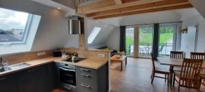 a kitchen and dining room with a table and a kitchen and a dining room at Ferienhof Bieke in Finnentrop