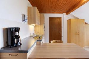 a kitchen with a coffee maker on a counter at Harmony Apt 1 in Appiano sulla Strada del Vino +20 photos