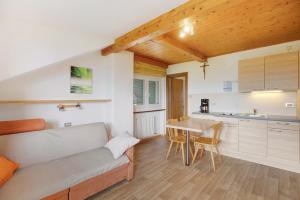 a living room with a couch and a table at Harmony Apt 1 in Appiano sulla Strada del Vino