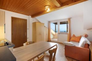 a living room with a dining room table and a bedroom at Harmony Apt 1 in Appiano sulla Strada del Vino