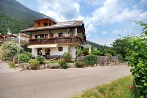 a house with a balcony on the side of a road at Harmony Apt 1 in Appiano sulla Strada del Vino