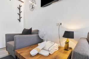 a living room with a couch and a table with a fan at Chabelas Loft in Lajita +16 photos