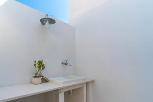 a white bathroom with a sink and a mirror at Dimora delle Riserve Naturali in Torre Colimena +21 photos