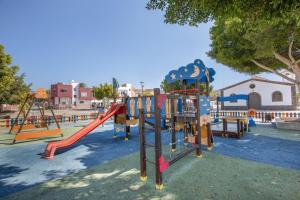 a park with a playground with a slide at Chabelas Loft in Lajita